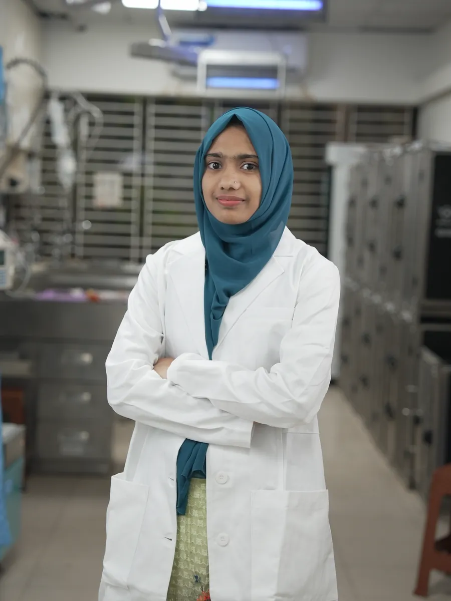 A veterinarian in a white coat standing in the hospital ward